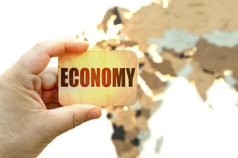 Against the background of the world map, a man holds a sign with the inscript Stock Photos
