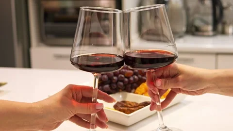 Against bright background of fruit two glasses click harmonious celebration In Video stock 273449843