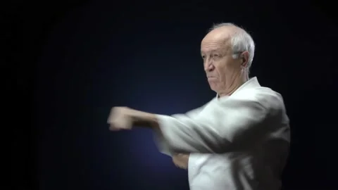 Against a dark blue background, an old athlete is training hand punches Stock Footage 139150732