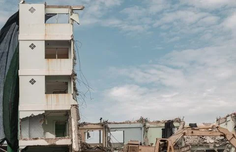 Against a soft, cloud-dappled sky, the stark remnant of a five-story concre.. Stock Photos
