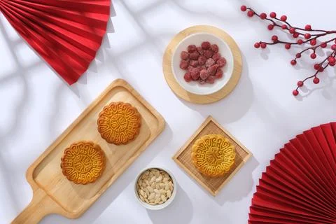 Against the white background with shadow of window, wooden trays of mooncakes Stock Photos