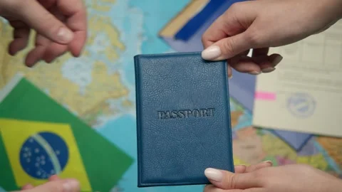 Against world map migration service worker issues Brazilian passport to citizen Stock Footage 331262710