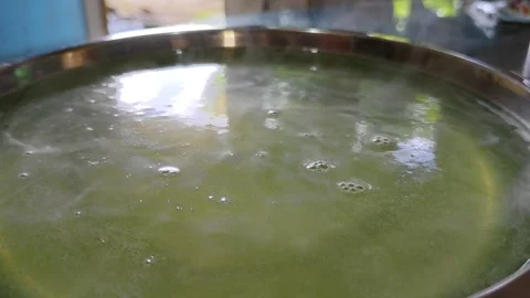 Agar agar bubbling in a metal container Stock Footage 304049026