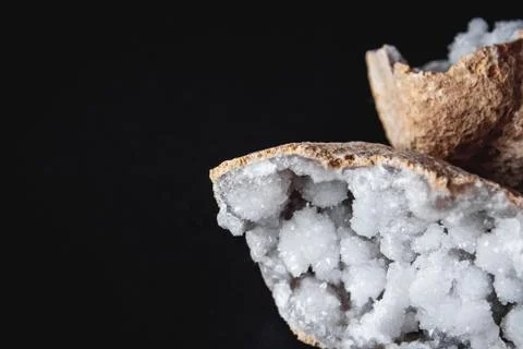 Agate. A cross section of agate stone with geode on a black background. Origi Stock Photos