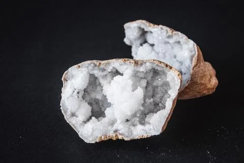 Agate. A cross section of agate stone with geode on a black background. Origi Stock Photos