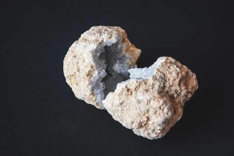 Agate. A cross section of agate stone with geode on a black background. Origi Stock Photos