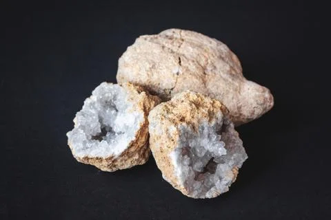 Agate. A cross section of agate stone with geode on a black background. Origi Stock Photos