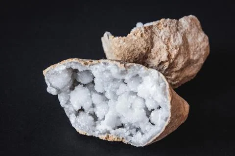 Agate. A cross section of agate stone with geode on a black background. Origi Stock Photos