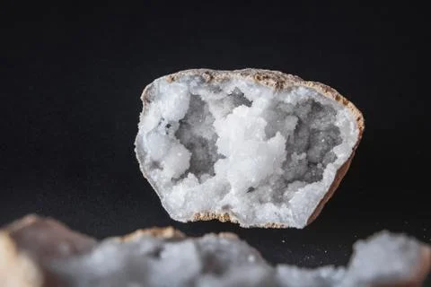 Agate. A cross section of agate stone with geode on a black background. Origi Stock Photos