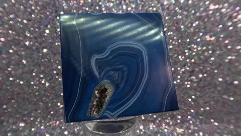 Agate gemstone with quartz inclusions in blue with blurred background Video stock 254356930