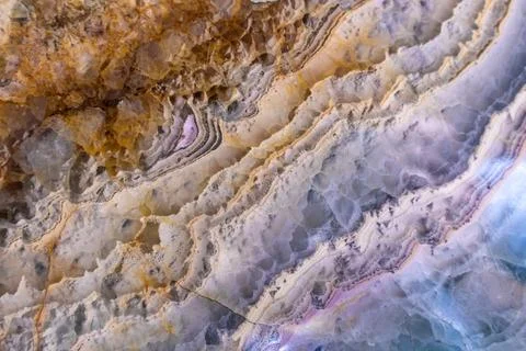 Agate stone close-up. Texture in waves. Natural Minerals. Abstract backdrop.  Stock Photos