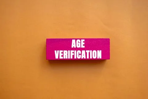 Age Verification message written on pink wooden block on orange background... Foto stock