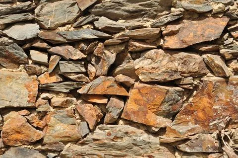 Aged and dirty surface texture built on different pieces of chipped stones Foto stock