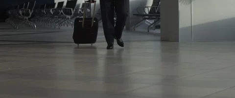 Aged aviator or pilot with or suitcase walks through empty airport terminal Stock Footage 120341642