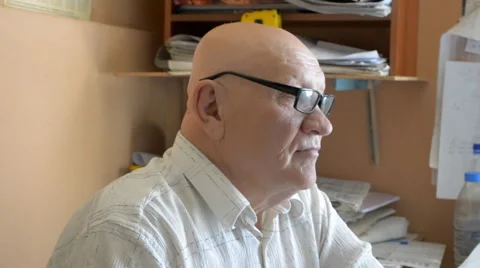 Aged bald man working at a computer Stock Footage 67377931