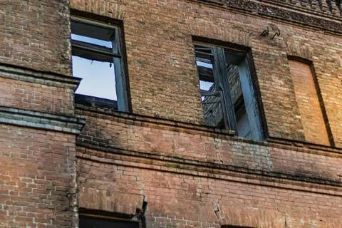 Aged Brick wall with broken windows Stock Photos