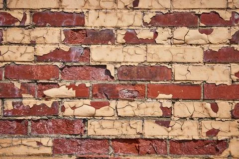 Aged Brick Wall Texture with Peeling Paint, Eye-Level View 스톡 사진