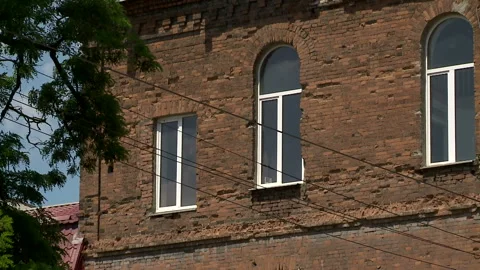Aged building facade with broken windows in old historical town, loneliness 스톡 동영상 90710141