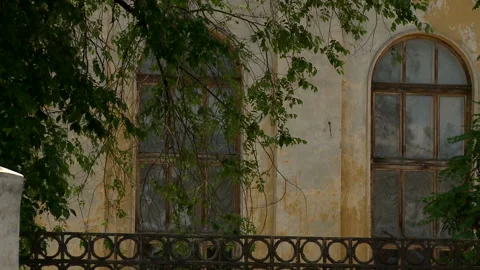 Aged building facade with broken windows in old historical town, loneliness Stock Footage 90711252