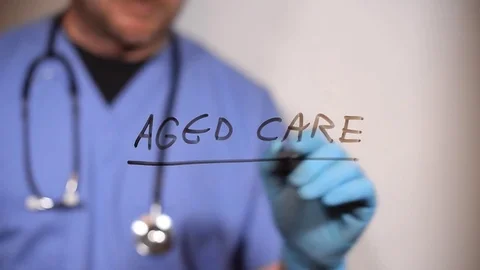 Aged care written on a clear screen on a board Stock Footage 79346456