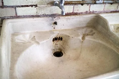 Aged Ceramic Sink With Worn Surface And Rust Stains Fotos Stock