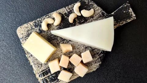 Aged cheese in a triangular block with jam, figs, and nuts. Aged cheese Stock Footage 336245100
