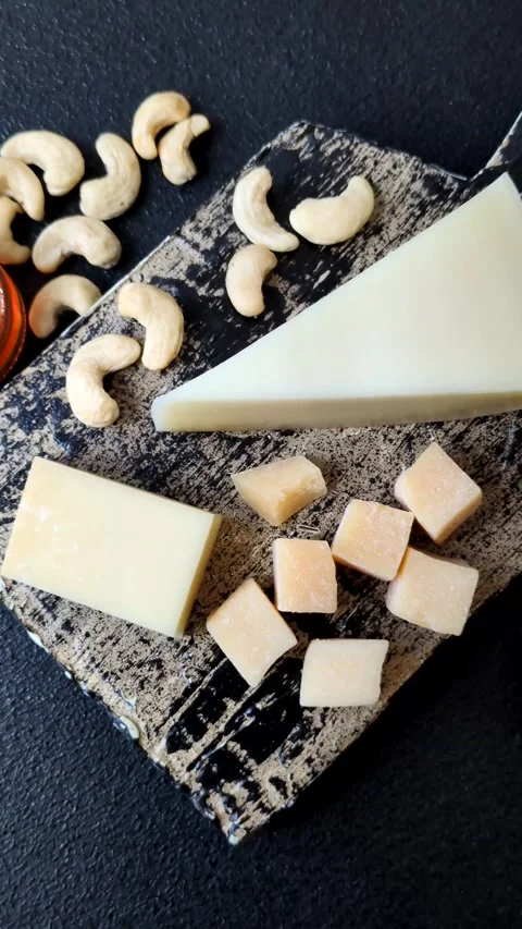 Aged cheese in a triangular block with jam, figs, and nuts. Aged cheese Stock Footage 336245105