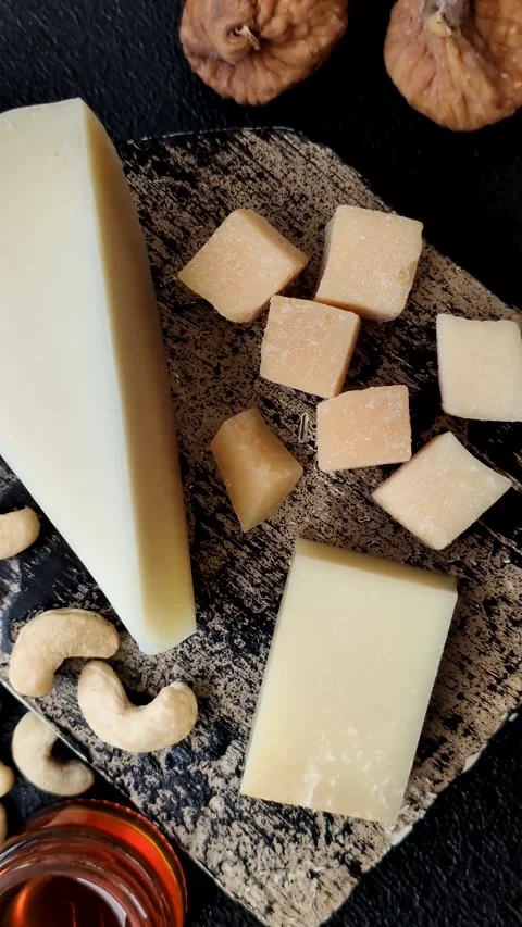 Aged cheese in a triangular block with jam, figs, and nuts. Aged cheese Stock Footage 336245109