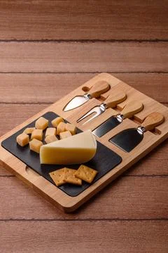 Aged cheese in a triangular block with jam, figs, and nuts. Aged cheese Stock Photos