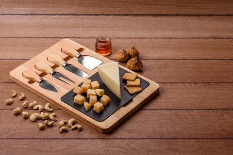 Aged cheese in a triangular block with jam, figs, and nuts. Aged cheese Stock Photos
