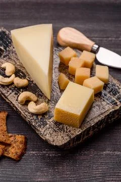 Aged cheese in a triangular block with jam, figs, and nuts. Aged cheese Stock Photos