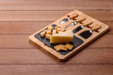 Aged cheese in a triangular block with jam, figs, and nuts. Aged cheese Stock Photos