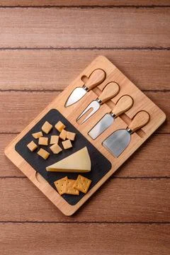 Aged cheese in a triangular block with jam, figs, and nuts. Aged cheese Stock Photos