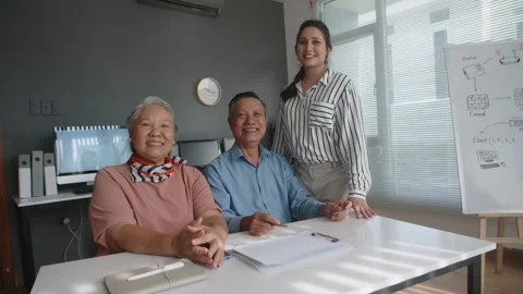 Aged Couple and Teacher Posing for Camera during Computer Class Stock Footage 263701417