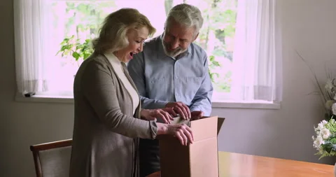 Aged couple open parcel feels satisfied by safe delivery services 動画素材 141523861
