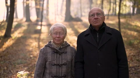 Aged couple posing during walk in autumn park Video stock 168186396