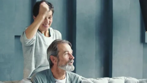 Aged couple sitting on the couch Stock Footage 155693425
