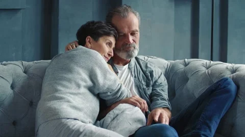 Aged couple sitting on the sofa Stock Footage 149407445