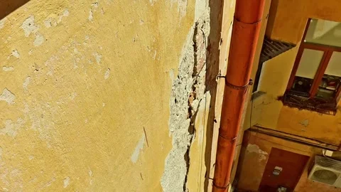 Aged Courtyard Wall with Drainpipe and Weathered Facade Detail Stock Footage 336839090
