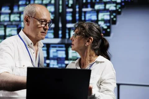 Aged developers working in data center Stock Photos