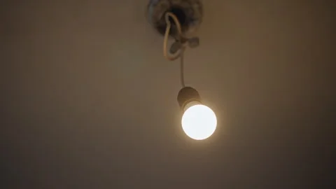 Aged electrical socket illuminating textured ceiling with gentle light. Ambient Vidéo 346545904