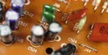 Aged Electronic Components Outdated Brown Board Closeup Old Circuits Background 4k or 4k+ Resolution