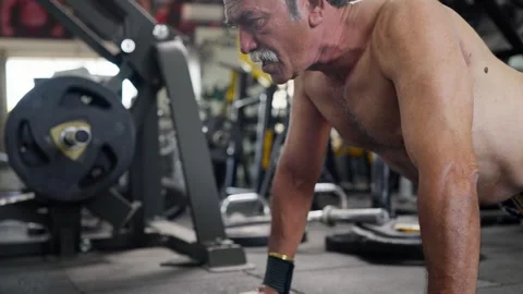 Aged fit Indian man performing bodyweight push ups in modern gym Video stock 341856023