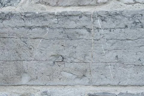 Aged gray masonry wall with rough rectangular stone block.  Stock Photos