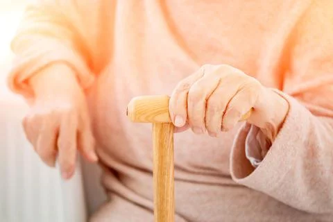 Aged hand with cane Stock Photos