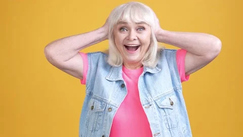 Aged lady impressed present message wear vest isolated vivid color background Stock Footage 189782048