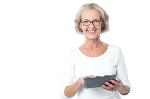 Aged lady operating touch pad device Stock Photos