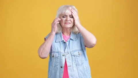 Aged lady suffer terrible headache fever isolated bright color background Stock Footage 189843300