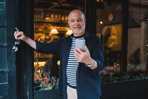 Aged man with smartphone tech using 4g internet for messaging and chatting in Stock Photos