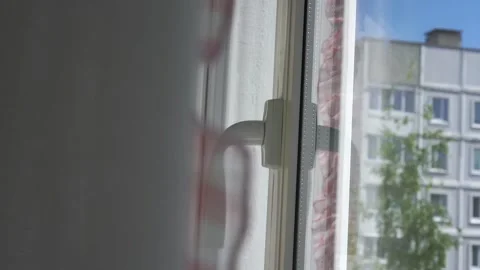 Aged man in yellow pullover hand opens plastic window Stock Footage 134998218